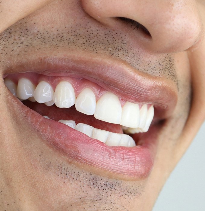 A closeup of a man’s smile