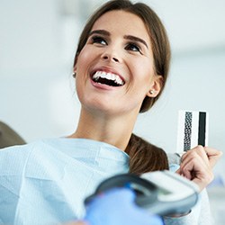 A woman paying for teeth whitening treatment