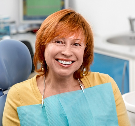 Woman sharing healthy smile after preventive dentistry treatment