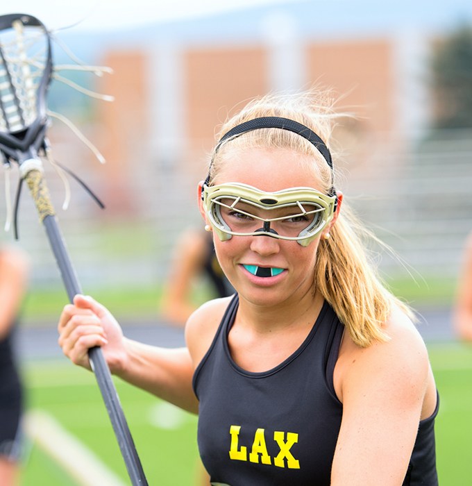 Teen girl with blue athletic mouthguard