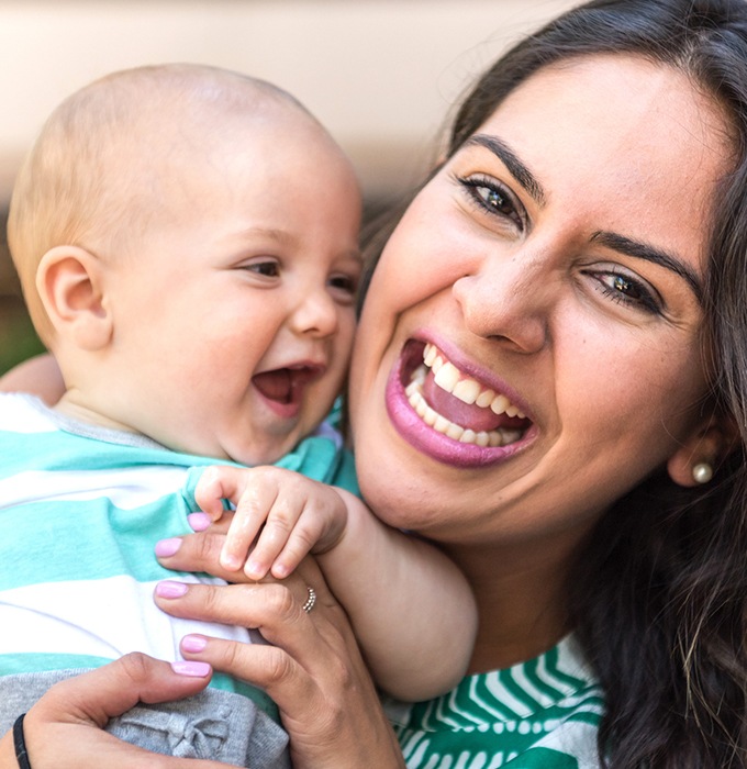 Mother and baby laughing after frenectomy treatment for lip and tongue tie