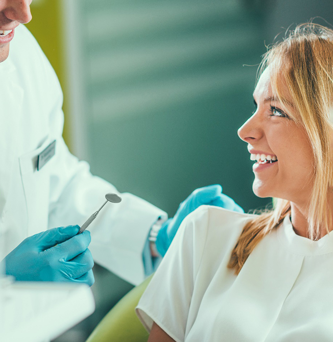 A young woman talking with her cosmetic dentist in Chelsea