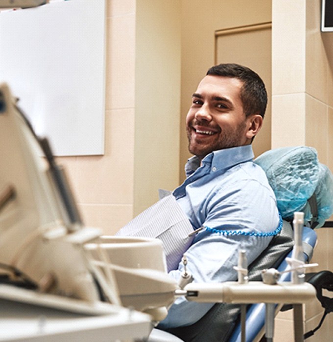 Dental patient smiling after successful implant salvage treatment