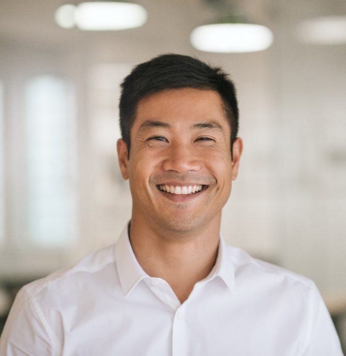 Man smiling in office with dental implants in Chelsea, MI