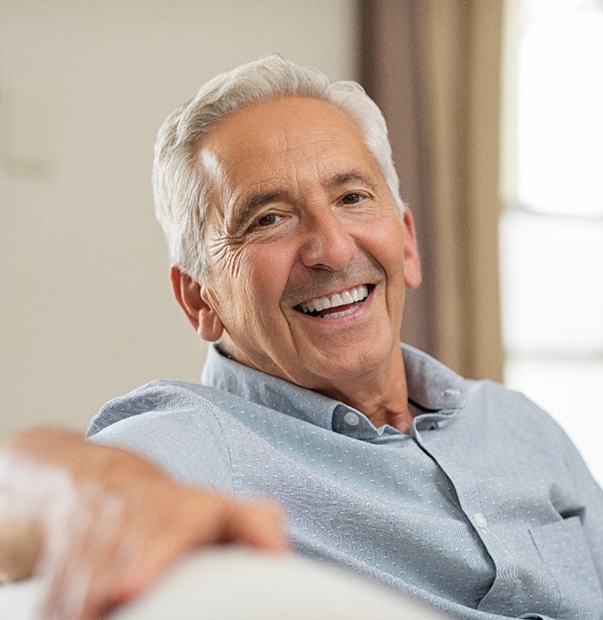 man smiling after getting dental implants in Chelsea