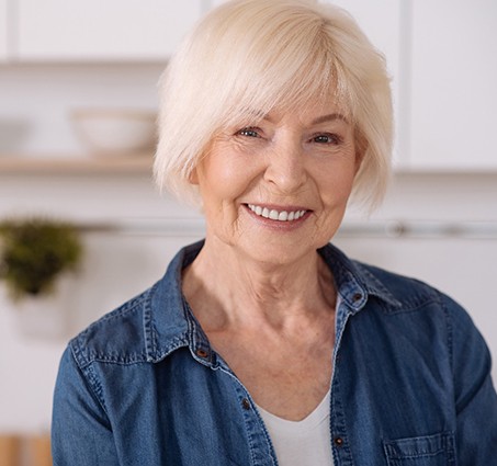 Senior woman with implant dentures in Chelsea, MI