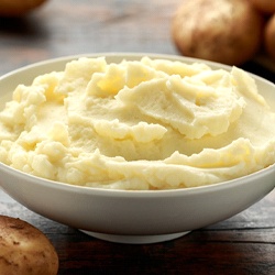 Mashed potatoes in a bowl on a wooden table