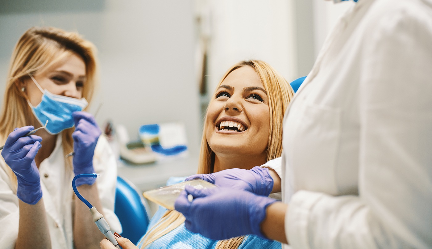 Woman laughing with dentist