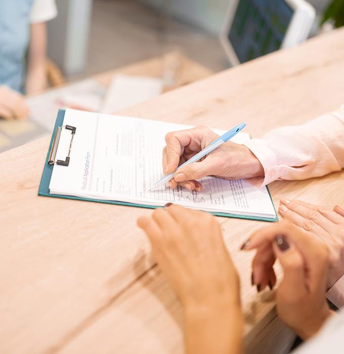 Patient filling out dental insurance forms