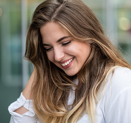 Woman with flawless smile after orthodontics