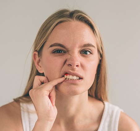 Woman with inflamed soft tissue in need of gum disease treatment