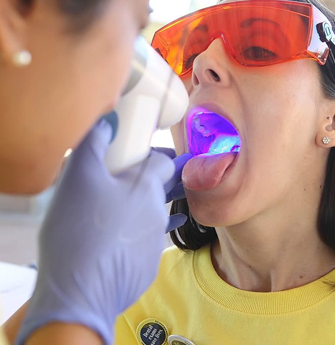 Dentist performing oral cancer screening