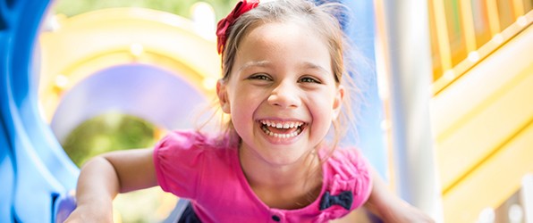 Little girl with healthy smile after children's dentistry visit