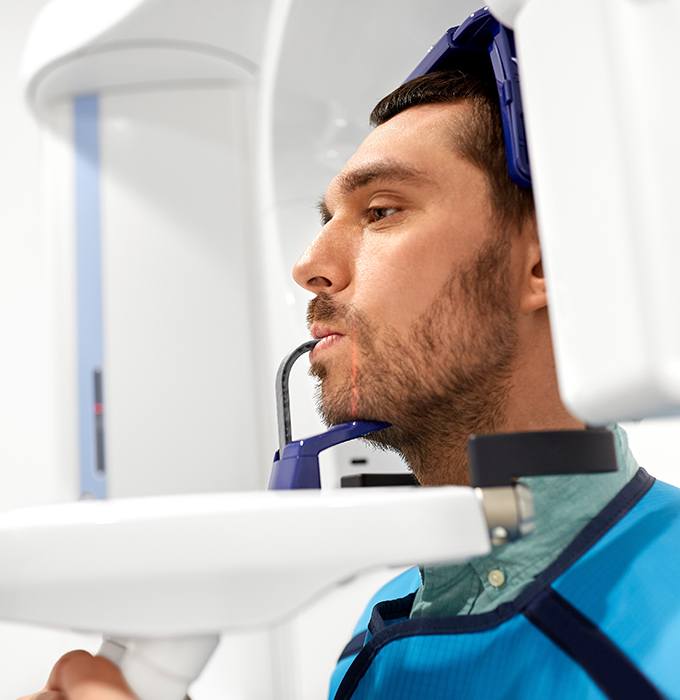 Man receiving C T cone beam dental x-ray scans