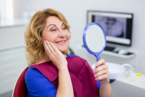 older woman happy with dental implants in Chelsea