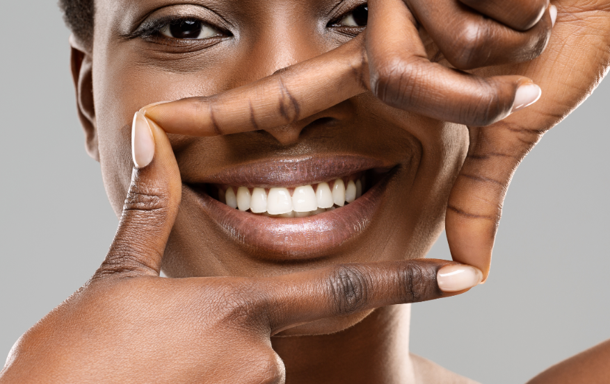 Woman framing smile with hands